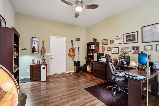 a view of a livingroom with furniture and bookshelf