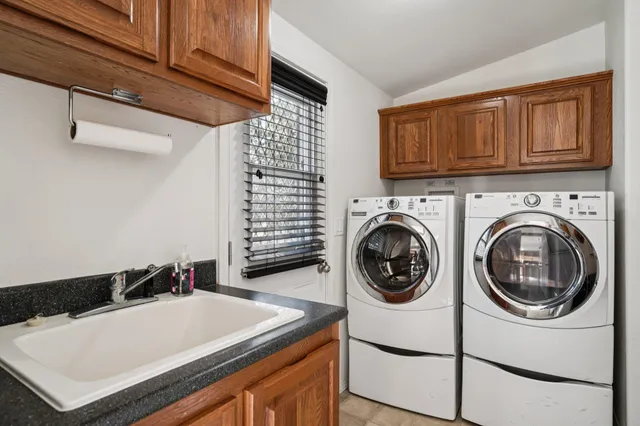 a bedroom with a bed window and a chandelier