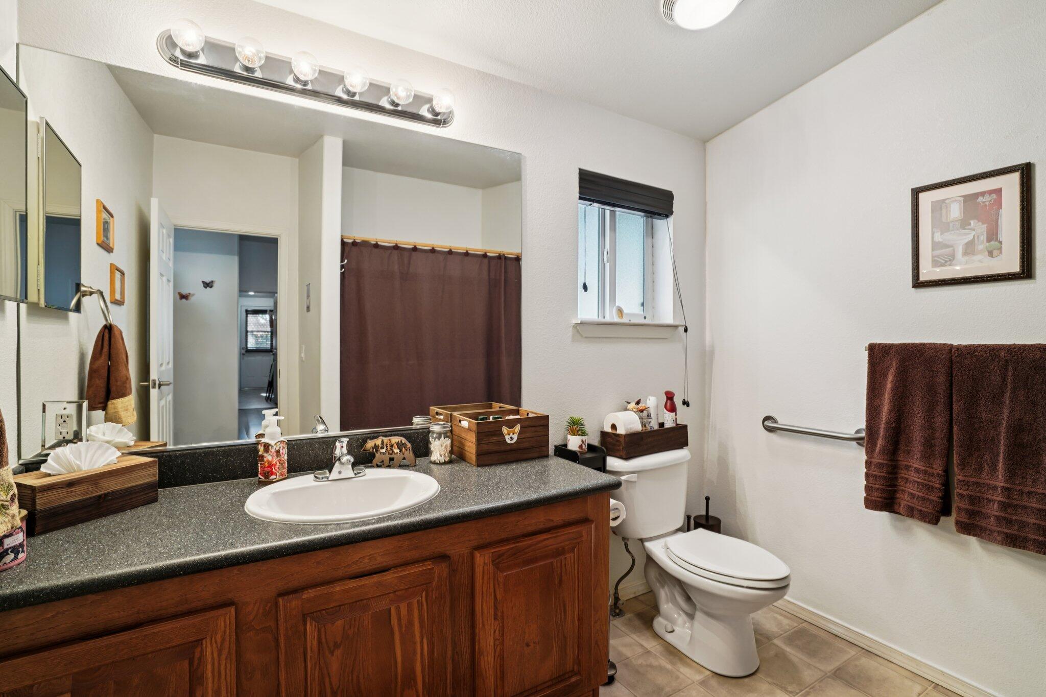 25001 Rim Rock Road Idyllwild, CA 92549 - Photo 38 of 49 a bathroom with a granite countertop sink and a mirror