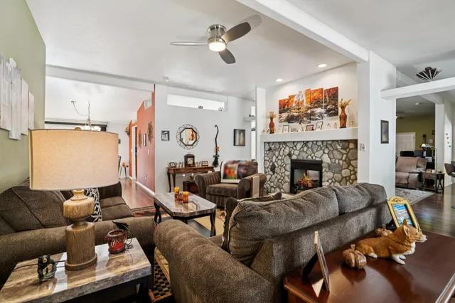 a living room with furniture ceiling fan and a rug