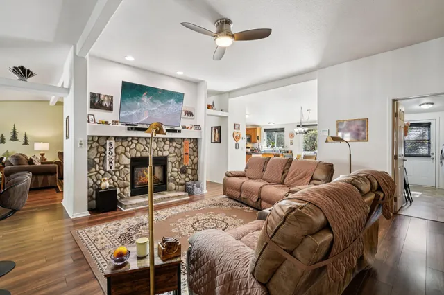 a living room with furniture a flat screen tv and a fireplace
