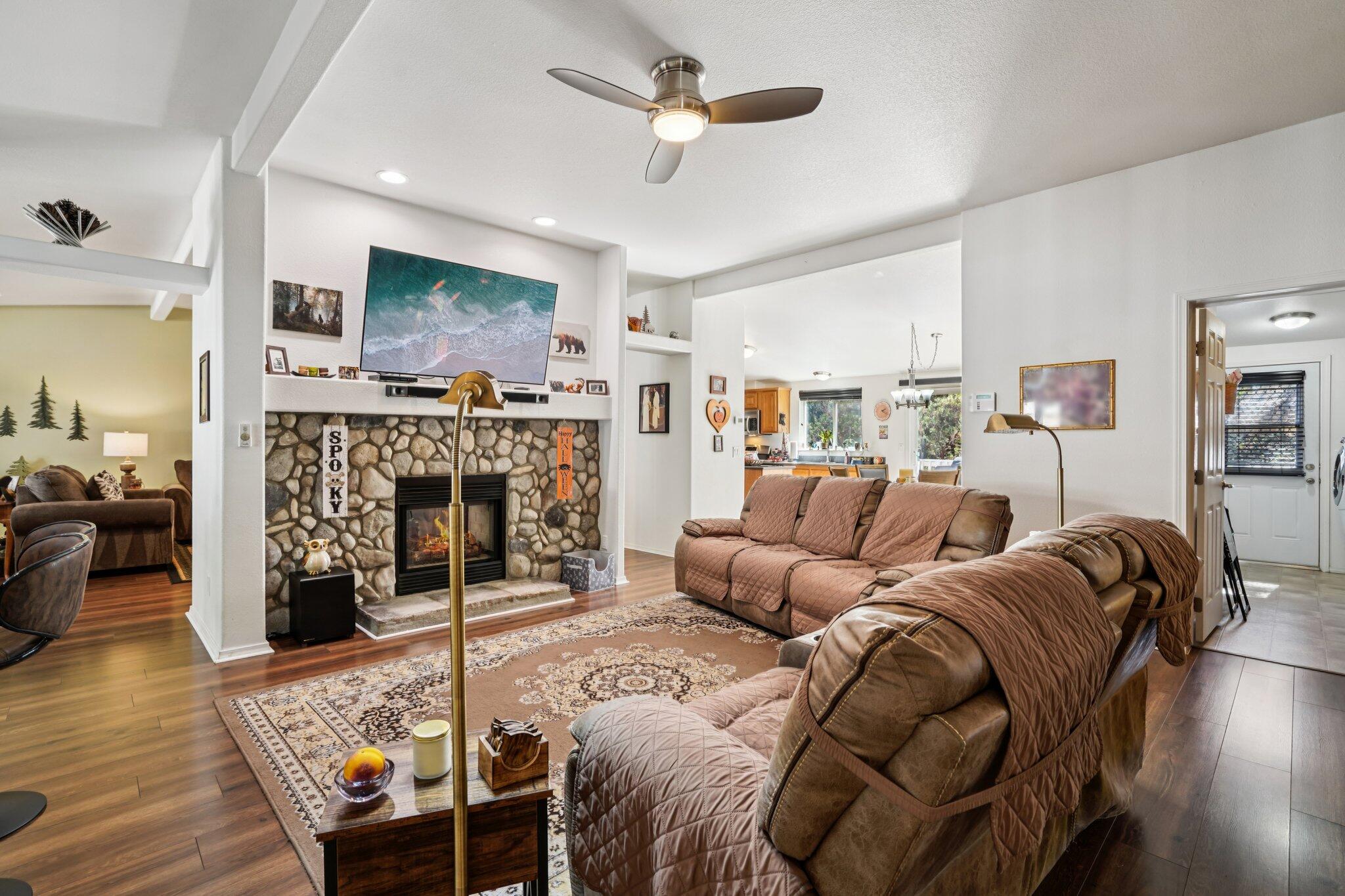 25001 Rim Rock Road Idyllwild, CA 92549 - Photo 10 of 49 a living room with furniture a flat screen tv and a fireplace