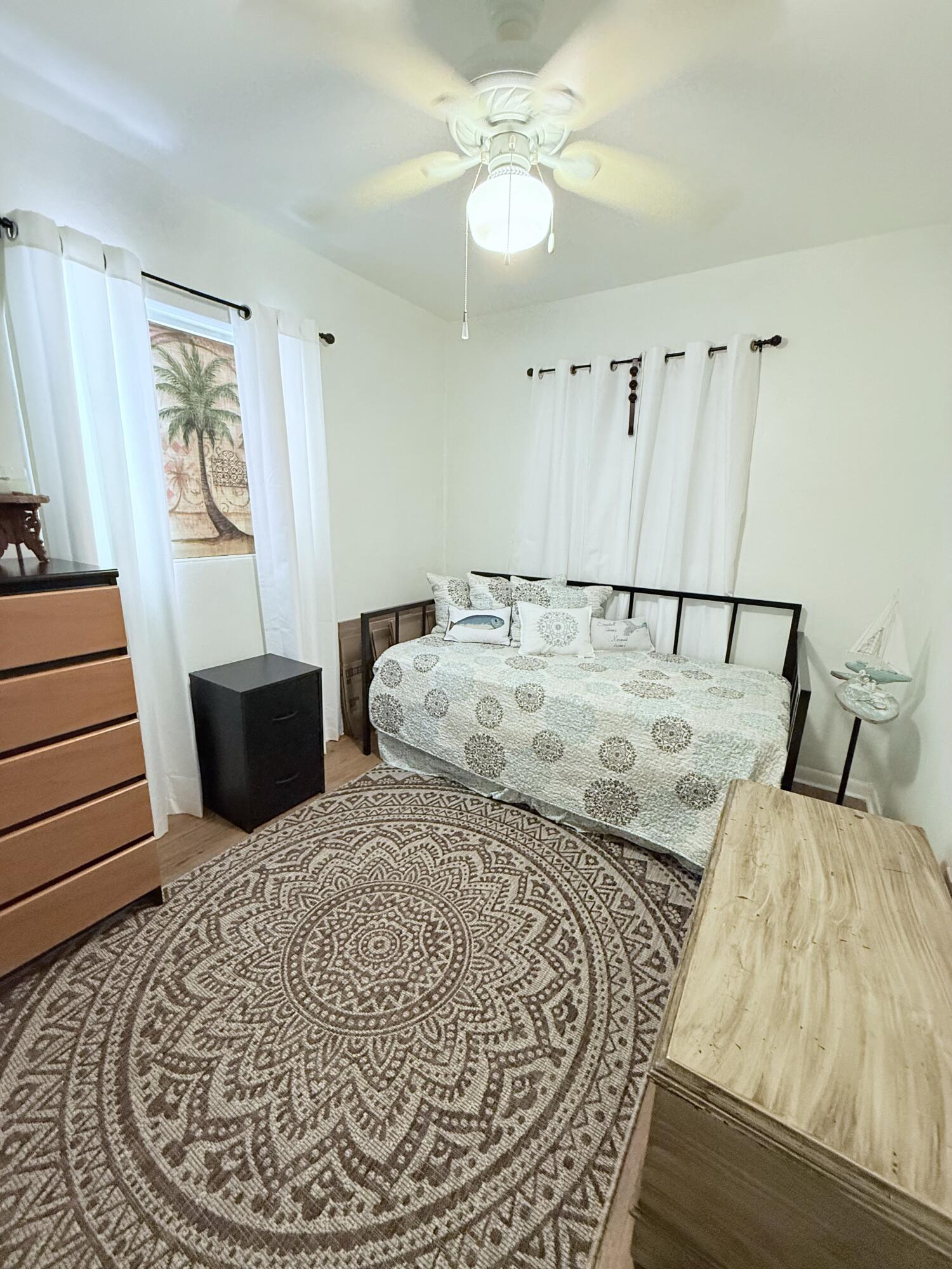 1736 Hunter Road Okeechobee, FL 34974 - Photo 23 of 35 a bedroom with a bed and wooden floor