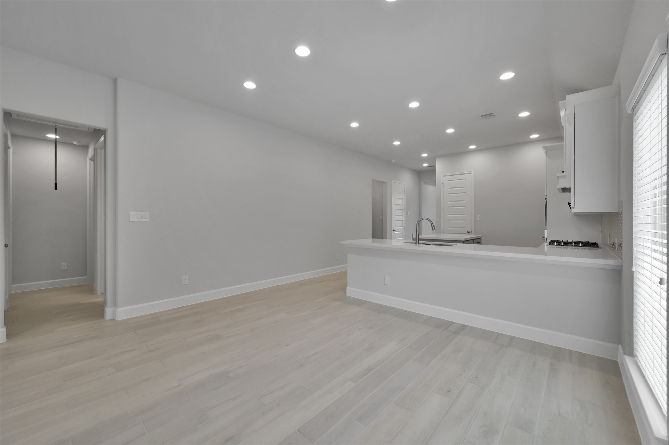 15715 Autumn Sun Conroe, TX 77302 - Photo 10 of 23 a view of an empty room with kitchen and window