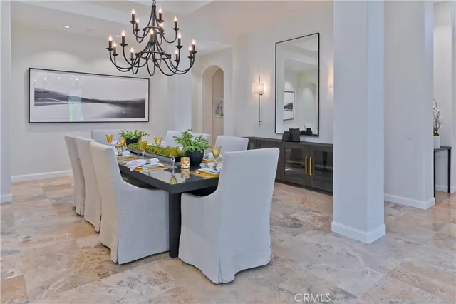 a view of a dining room with furniture and chandelier