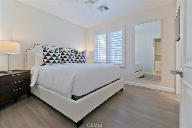 a bedroom with a bed and a night stand