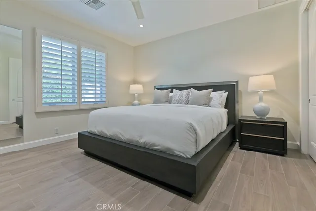 a bedroom with a bed and a night stand