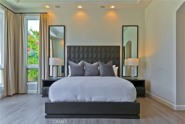 a large bed sitting in a bedroom next to a window