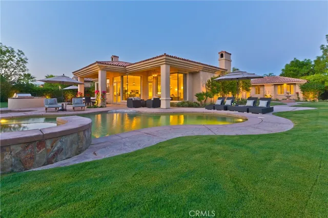 a view of a house with swimming pool and a yard