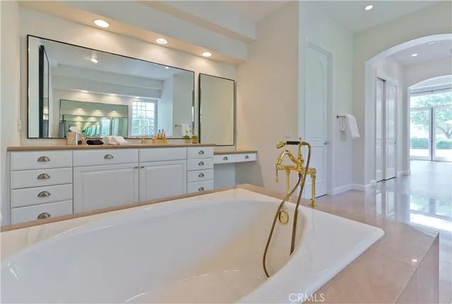 a room with a sink a chandelier and living room