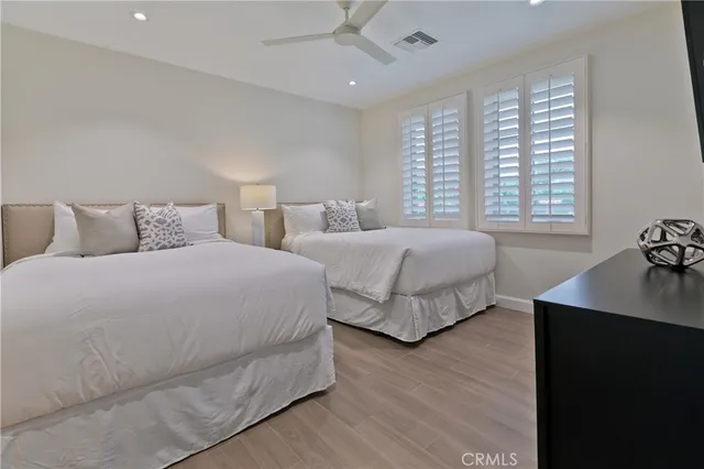 a bedroom with two beds and a dresser