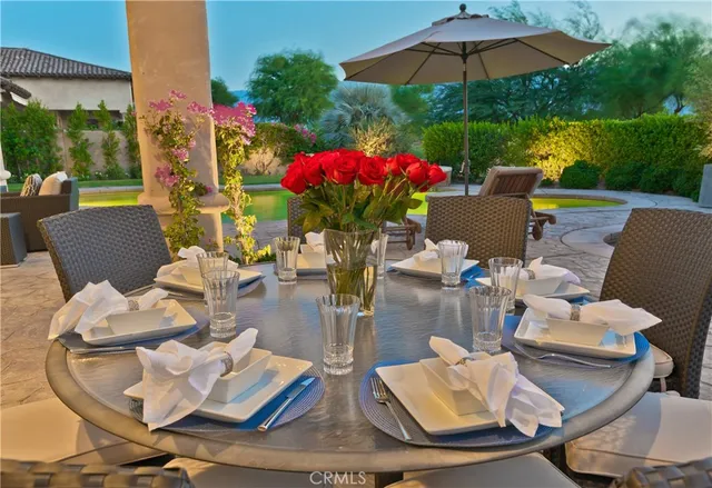 a outdoor living space with furniture and umbrella