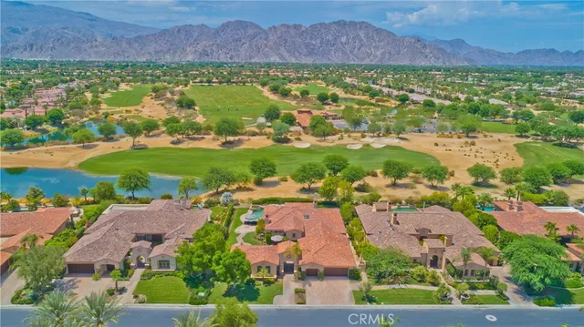 an aerial view of a house with a yard and basket ball court