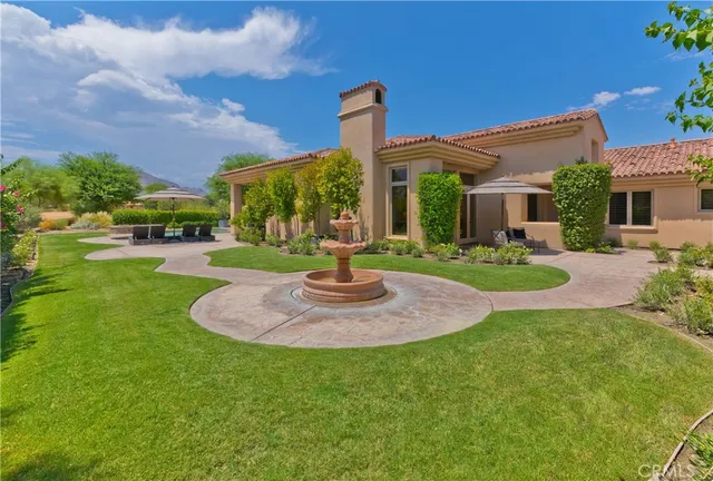 a front view of a house with swimming pool having outdoor seating