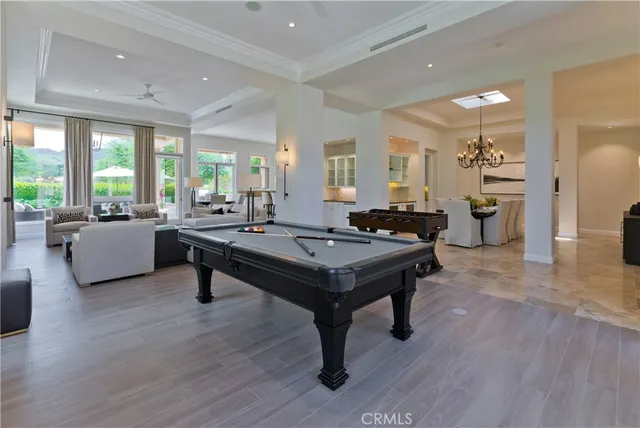 a living room with furniture a table and wooden floor