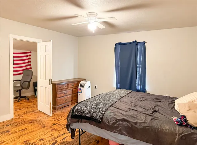 a view of hallway with closet and wooden floor