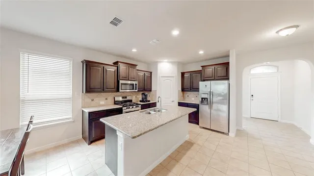 a kitchen with a refrigerator and a sink