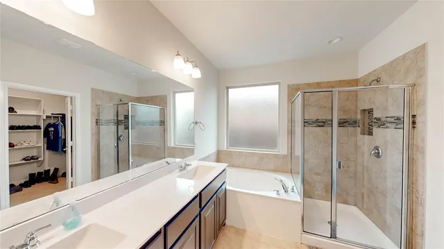 a bathroom with a granite countertop sink mirror and shower