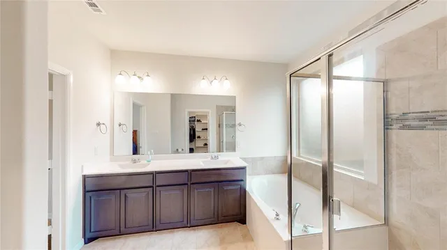 a bathroom with a double vanity sink and a mirror