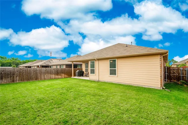 a view of a house with a yard and sitting area