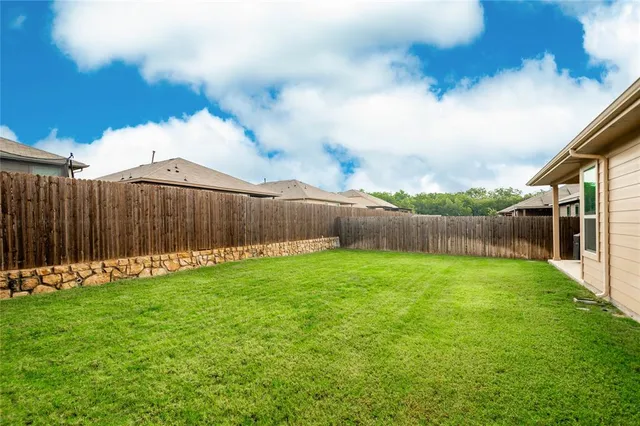 a backyard of a house with lots of green space