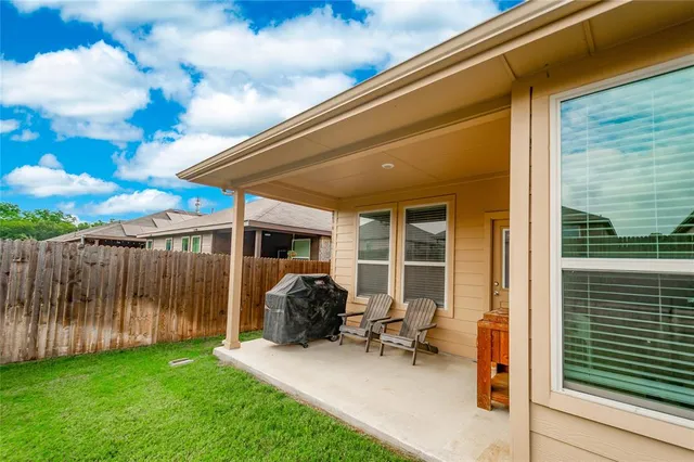 a backyard of a house with table and chairs
