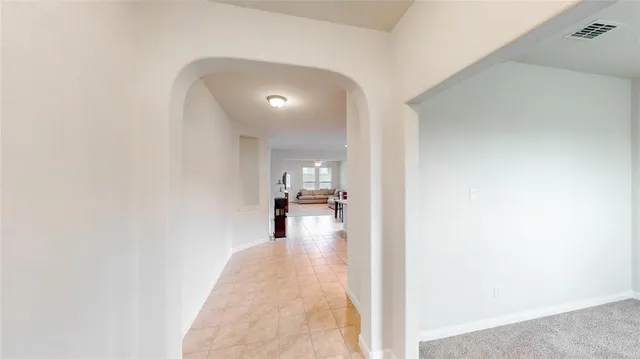a view of a living room with a white bed