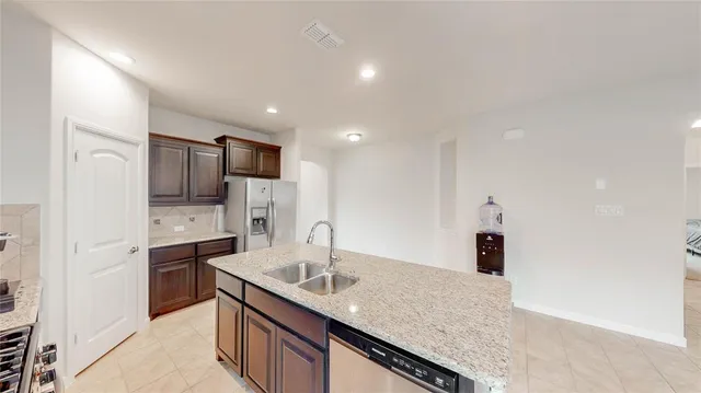 a kitchen with stainless steel appliances granite countertop a sink and cabinets