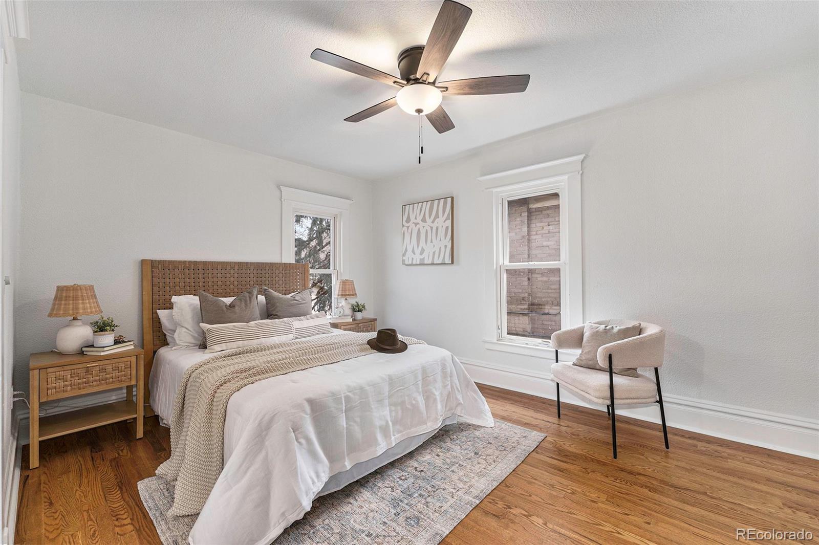 1314 Vine Street Denver, CO 80206 - Photo 13 of 34 a bedroom with bed and window with wooden floor