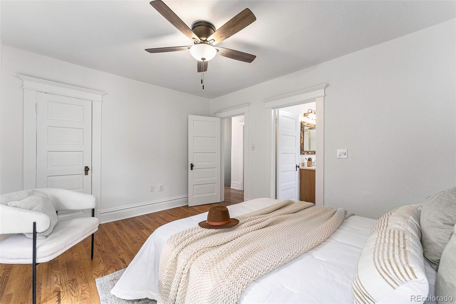 1314 Vine Street Denver, CO 80206 - Photo 14 of 34 a bedroom with a large bed and a chandelier