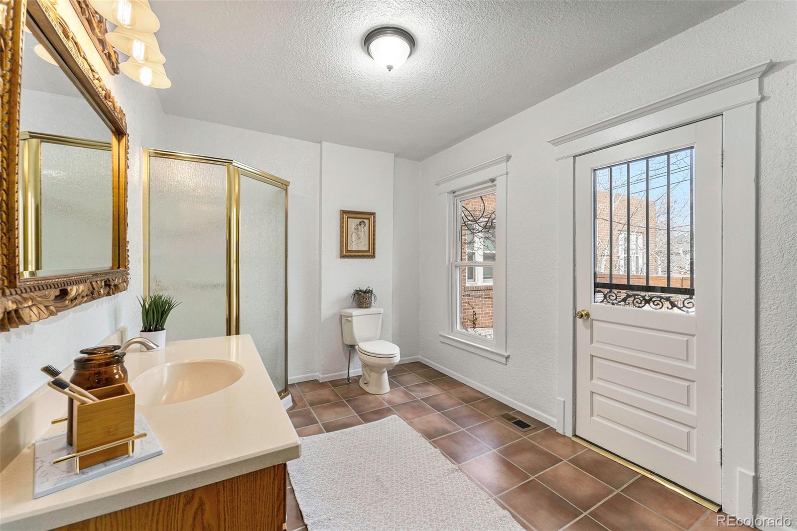 1314 Vine Street Denver, CO 80206 - Photo 15 of 34 a living room with furniture and a window