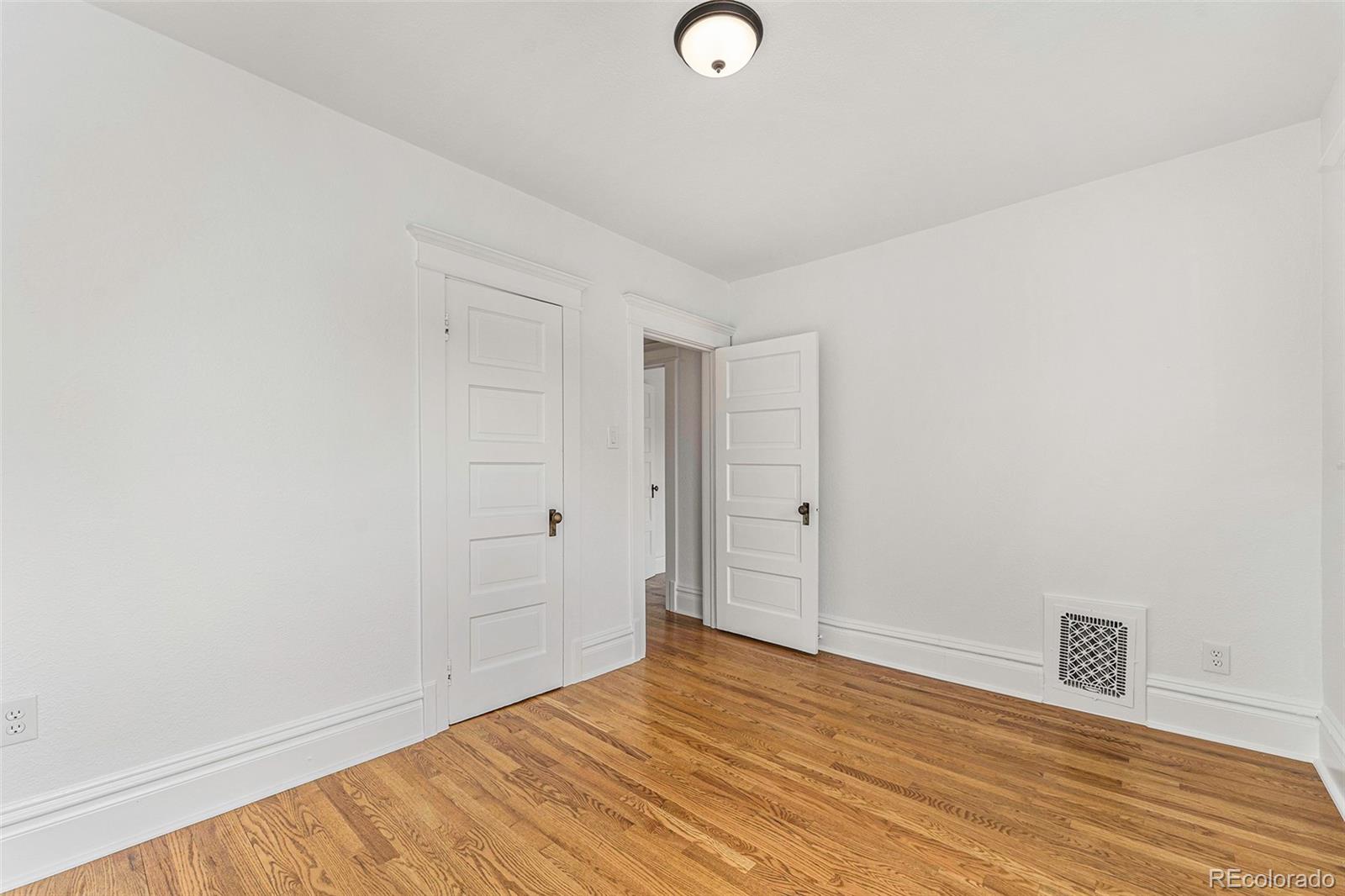 1314 Vine Street Denver, CO 80206 - Photo 18 of 34 a view of empty room with wooden floor