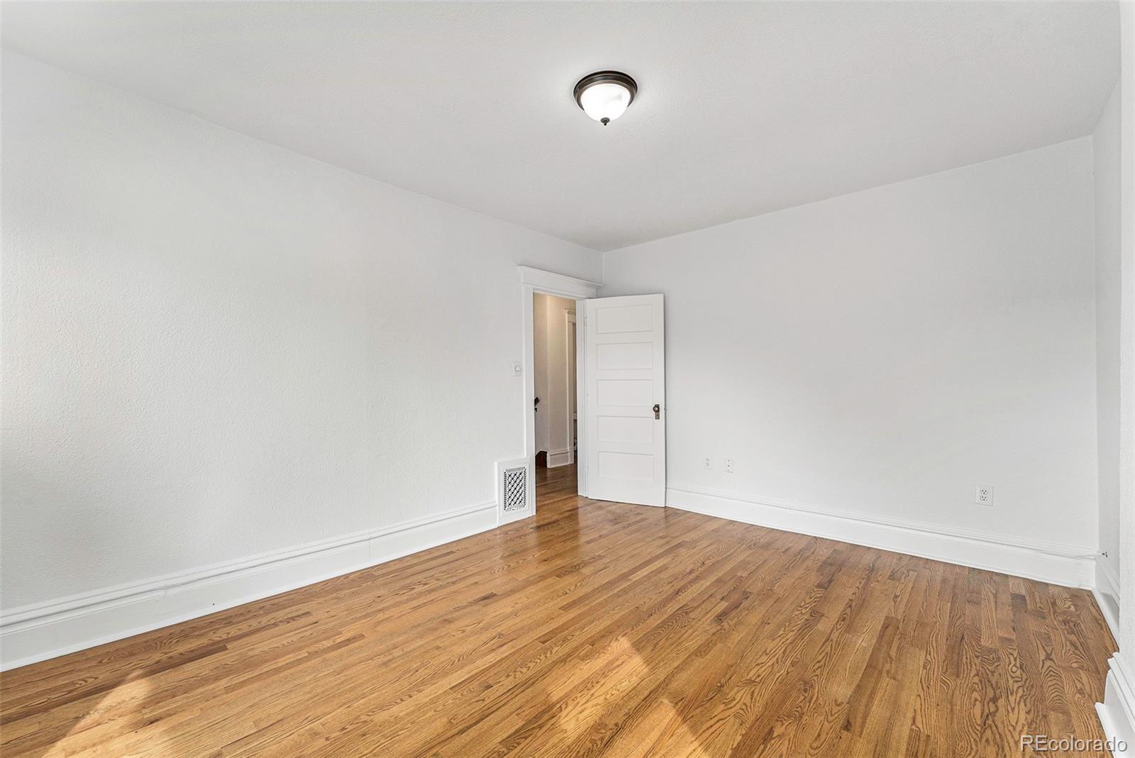 1314 Vine Street Denver, CO 80206 - Photo 20 of 34 a view of an empty room with wooden floor