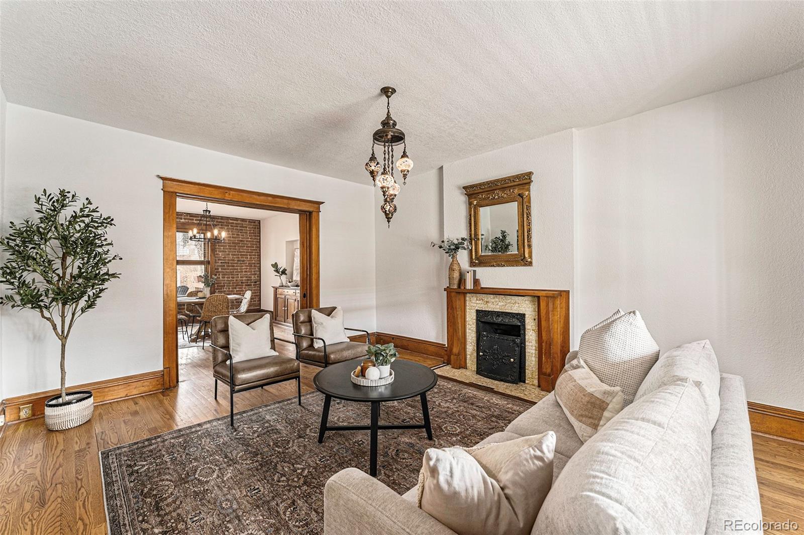 1314 Vine Street Denver, CO 80206 - Photo 5 of 34 a living room with furniture a window and a fireplace
