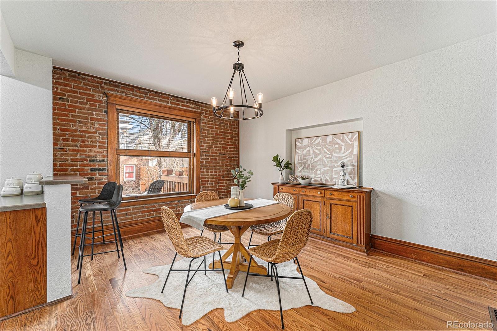 1314 Vine Street Denver, CO 80206 - Photo 7 of 34 a dining room with furniture a chandelier and wooden floor