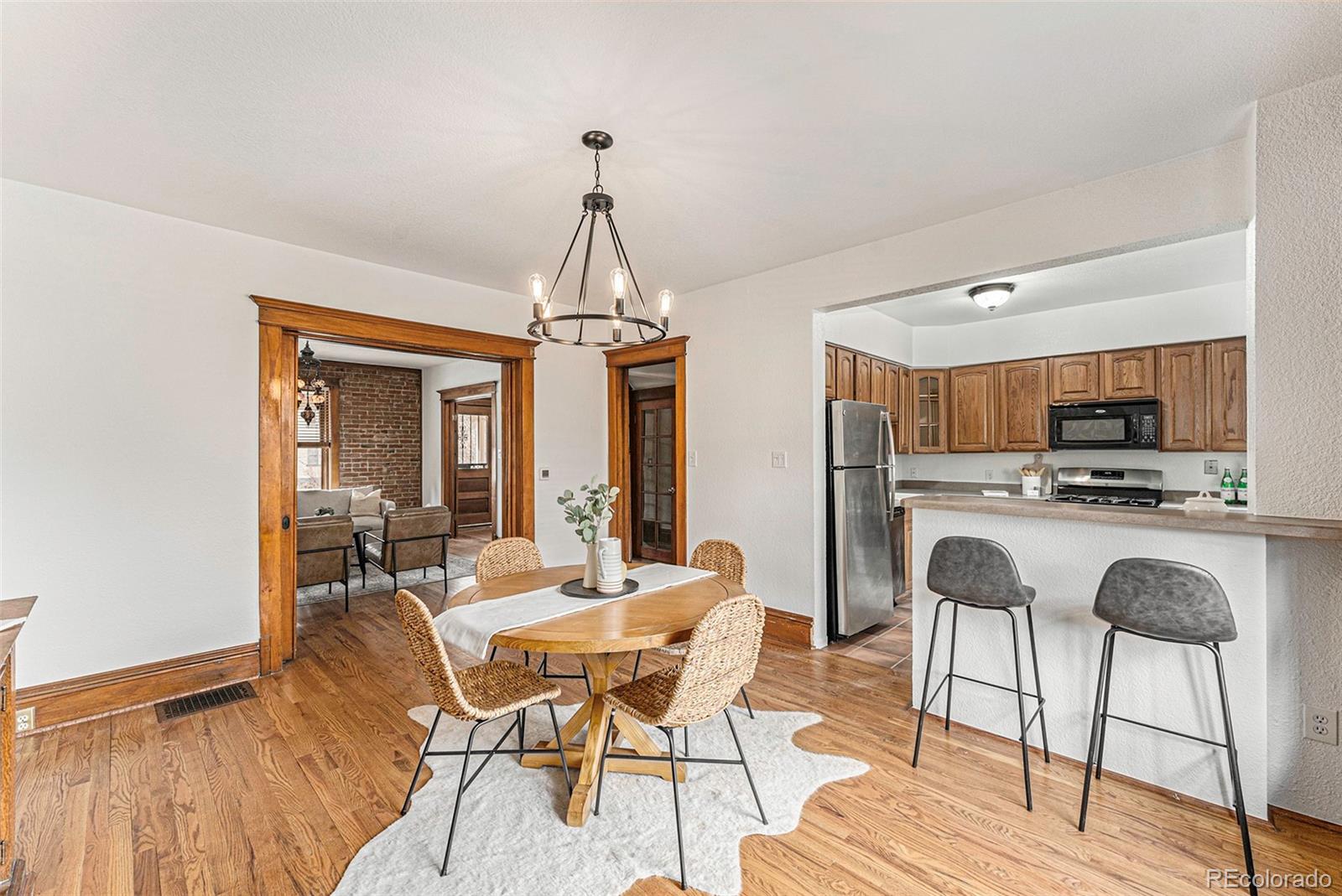1314 Vine Street Denver, CO 80206 - Photo 8 of 34 a view of a dining room with furniture and wooden floor