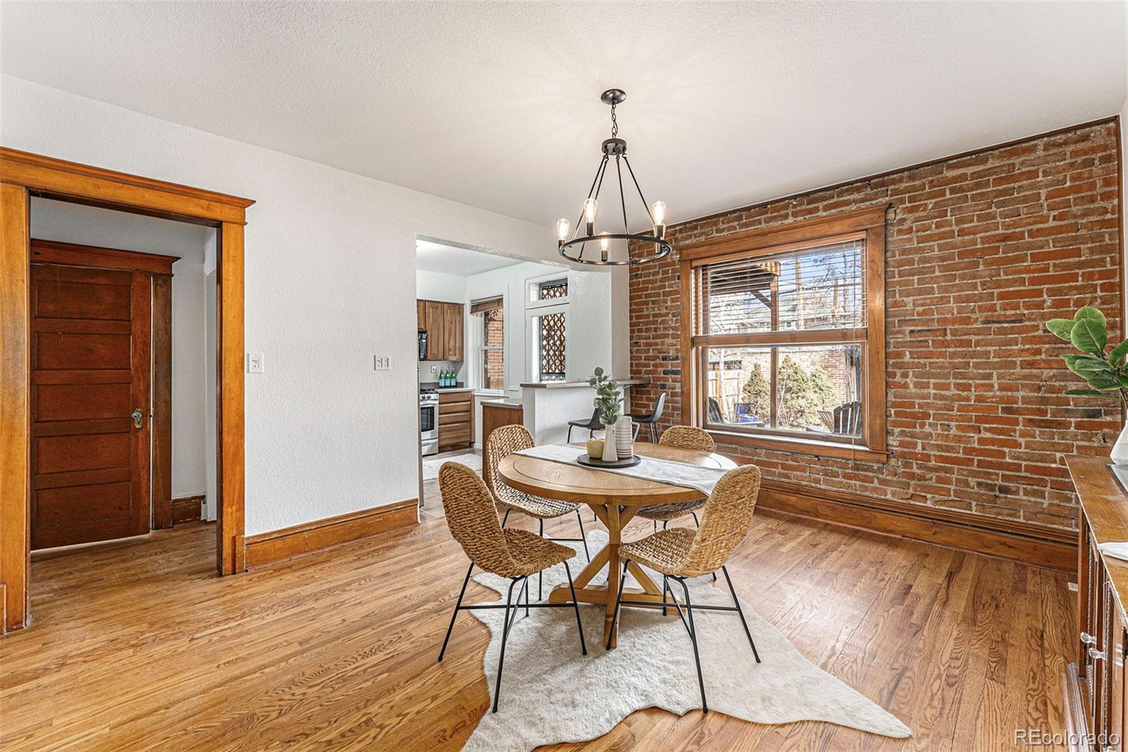 1314 Vine Street Denver, CO 80206 - Photo 9 of 34 a view of a dining room with furniture window and wooden floor