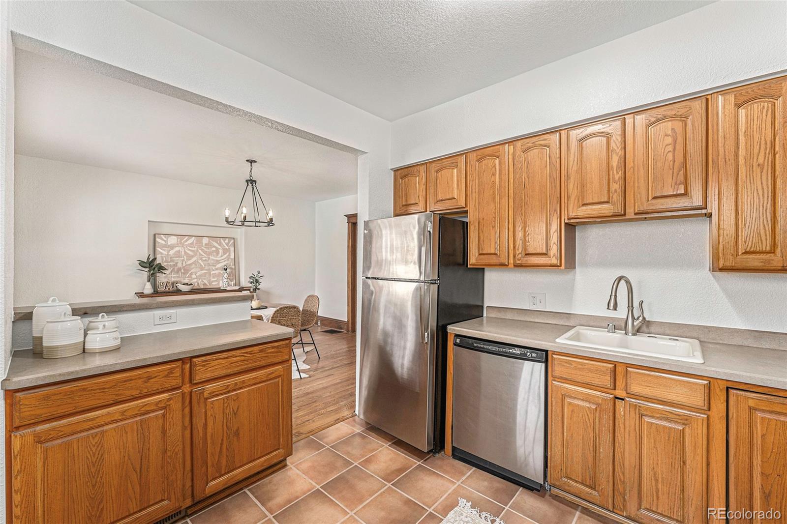 1314 Vine Street Denver, CO 80206 - Photo 10 of 34 a kitchen with stainless steel appliances granite countertop a sink stove and refrigerator