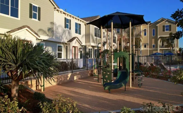 a view of a house with a small yard and potted plants