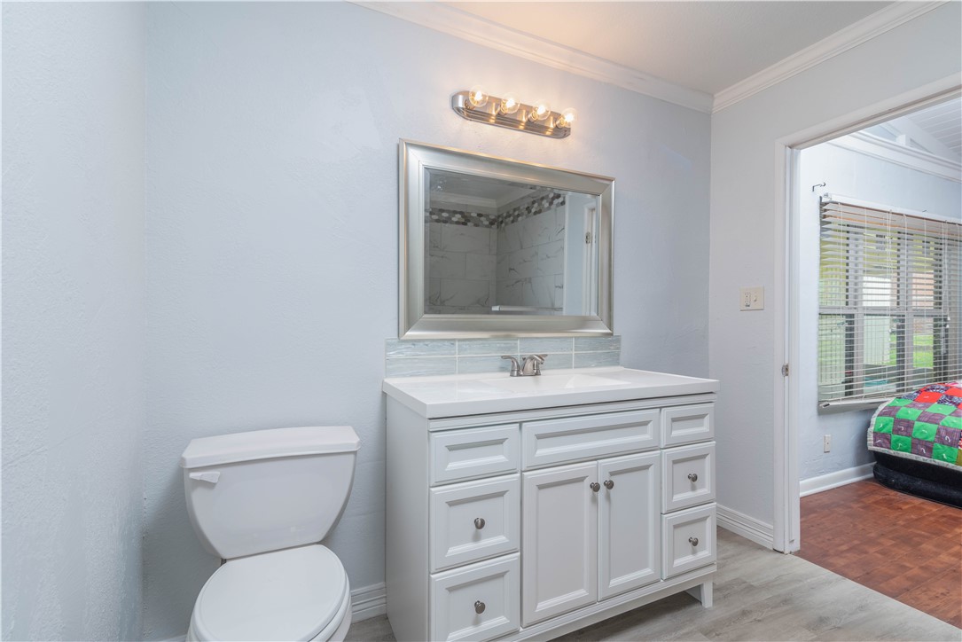 143 Trail Ridge Drive Sandia, TX 78383 - Photo 14 of 40 a bathroom with a toilet sink and mirror