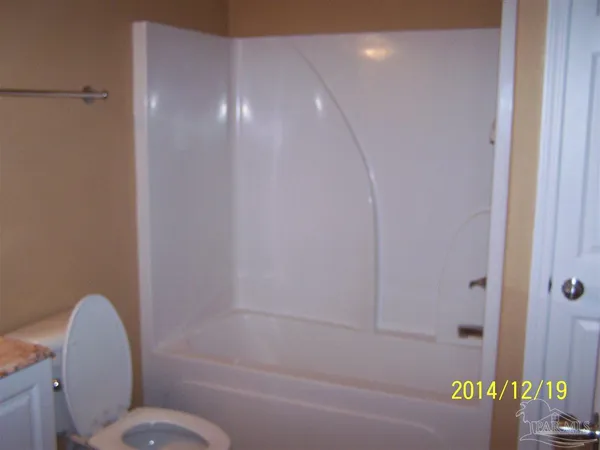 a bathroom with a toilet and shower