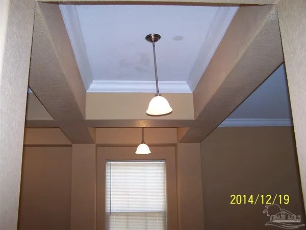 a view of a chandelier fan and entryway