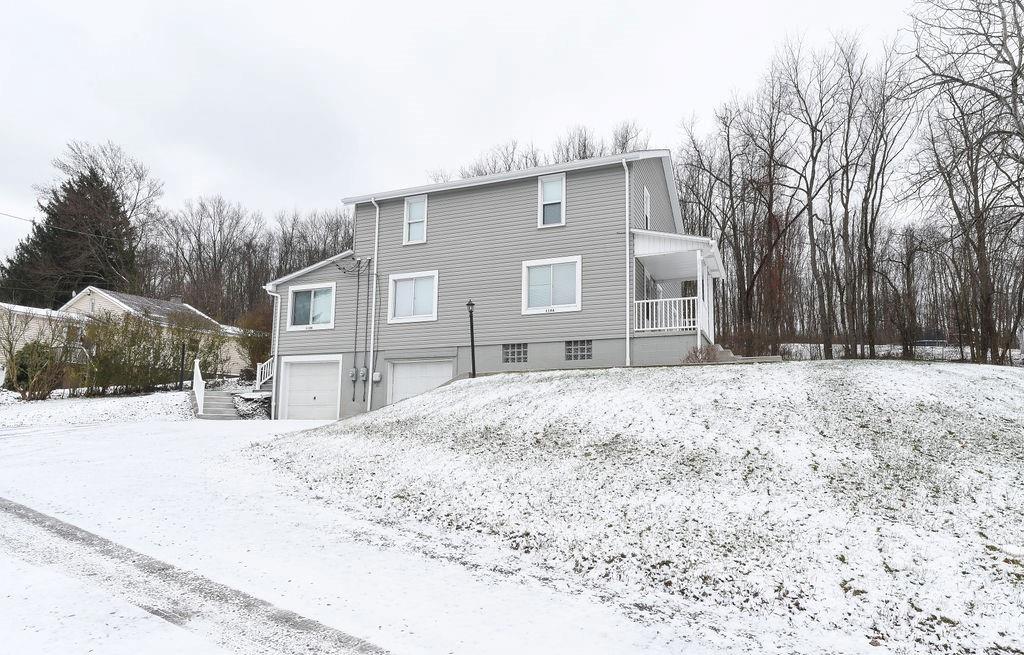 a backyard of a house with large trees