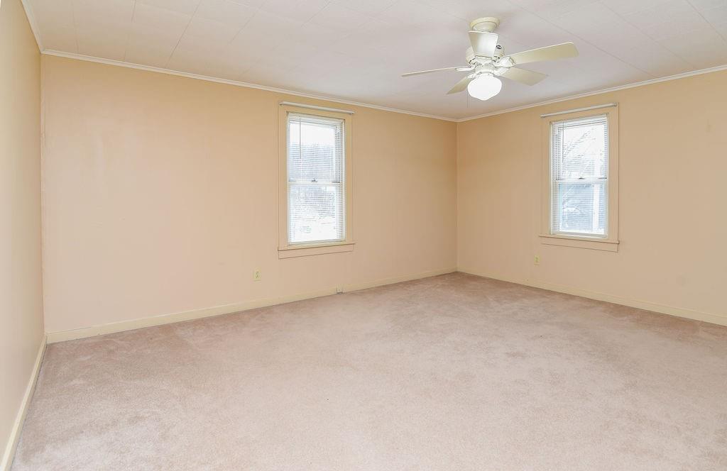 110 Gill Drive Beaver Falls, PA 15010 - Photo 11 of 25 an empty room with windows and ceiling fan