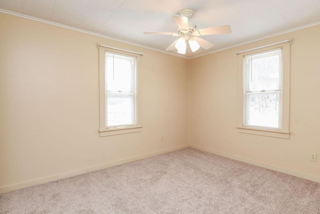 110 Gill Drive Beaver Falls, PA 15010 - Photo 12 of 25 an empty room with windows and chandelier fan