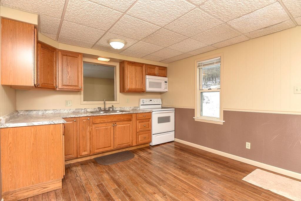 110 Gill Drive Beaver Falls, PA 15010 - Photo 8 of 25 a large kitchen with granite countertop a sink window and cabinets