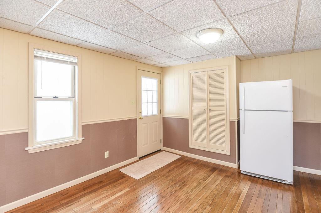 110 Gill Drive Beaver Falls, PA 15010 - Photo 10 of 25 a view of empty room with wooden floor and fan