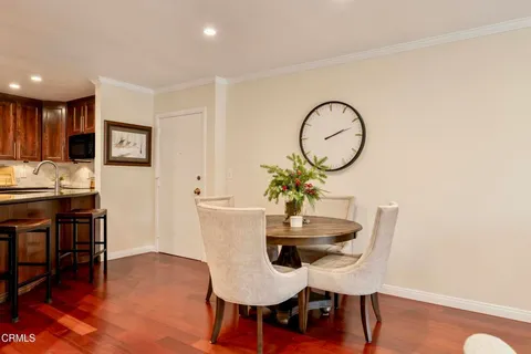 a dining room with furniture and wooden floor