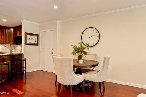 a view of a dining room with furniture and wooden floor