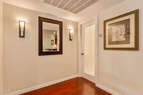 a view of a hallway with wooden floor